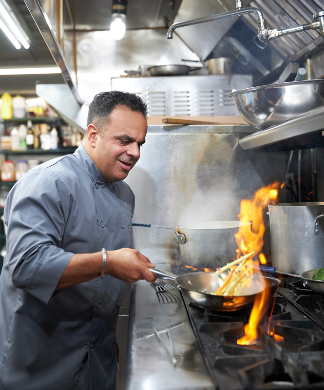 Chef Bobby Nahra cooking over an open flame